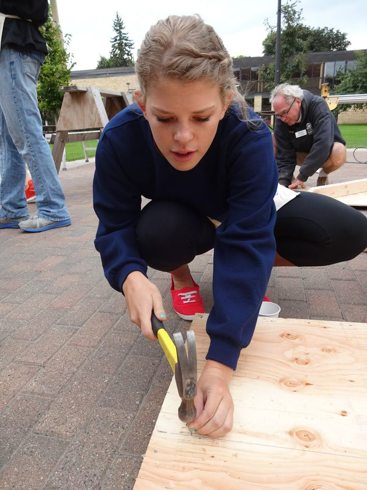 Sophomore Tori Benders works on a playhouse for the foundation last Saturday. Submitted photo.