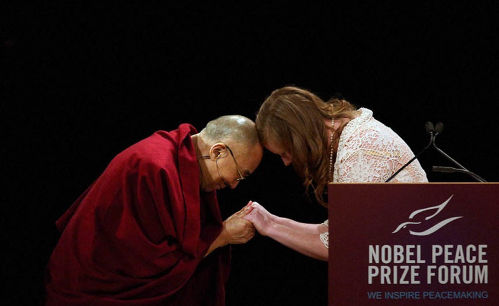 Anastasia Young and the Dalai Lama meet onstage at the Nobel Peace Prize Forum earlier this month. Photo courtesy of Nobel Peace Prize Forum.