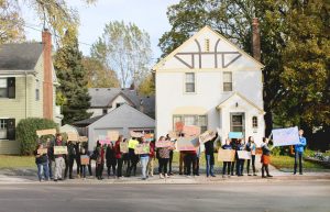 Concordia and MSUM students march with posters along 8th street. Photo by Maddie Malat.