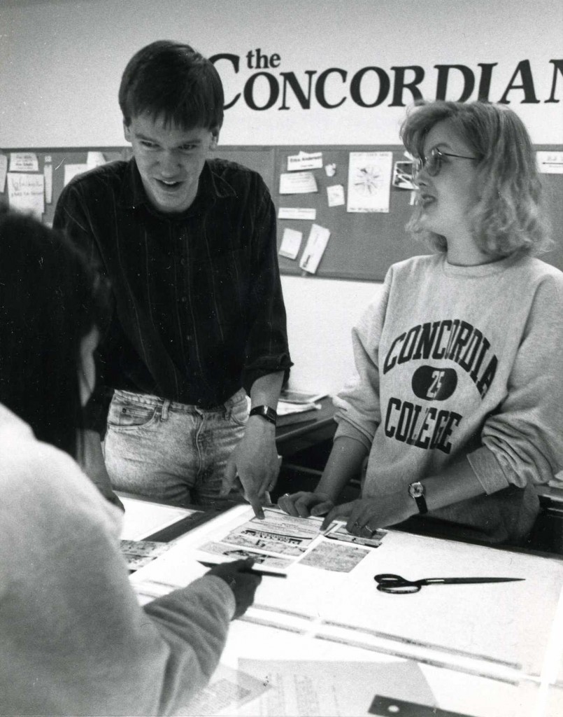 Dean Gulstad (editor), Jennifer Guggisberg (technical director), and another student lean over a table discussing the layout of The Concordian. Courtesy of the Concordia College Archives.