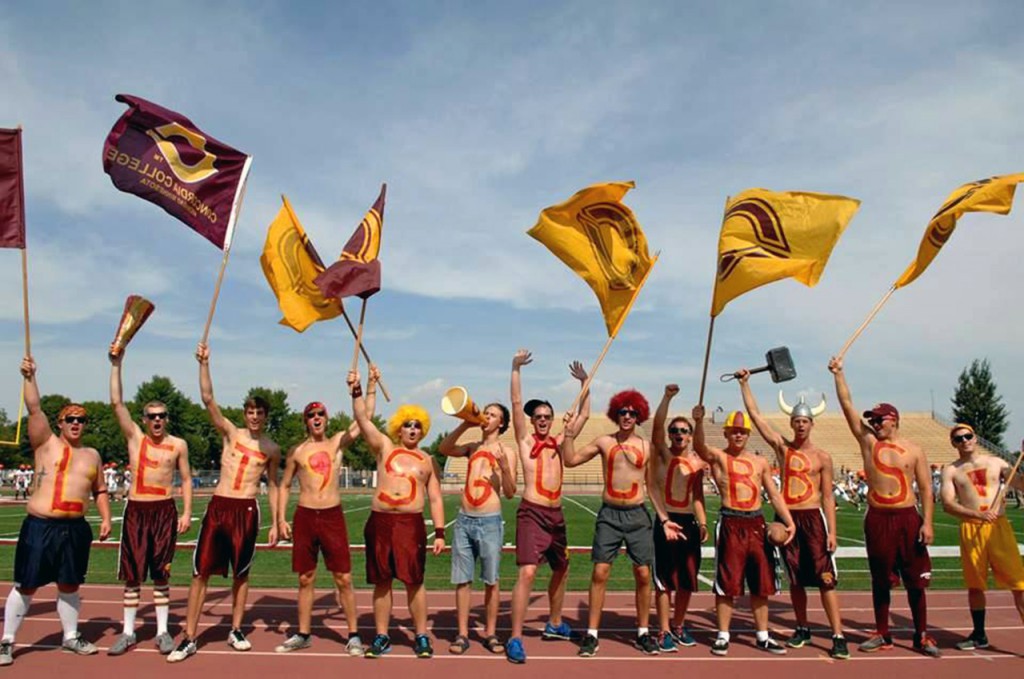 Cobber Nation gets the crowd revved up at a Cobber football game spelling out, "Let's Go Cobbs!" on their chests and waving Concordia flags. Submitted photo.