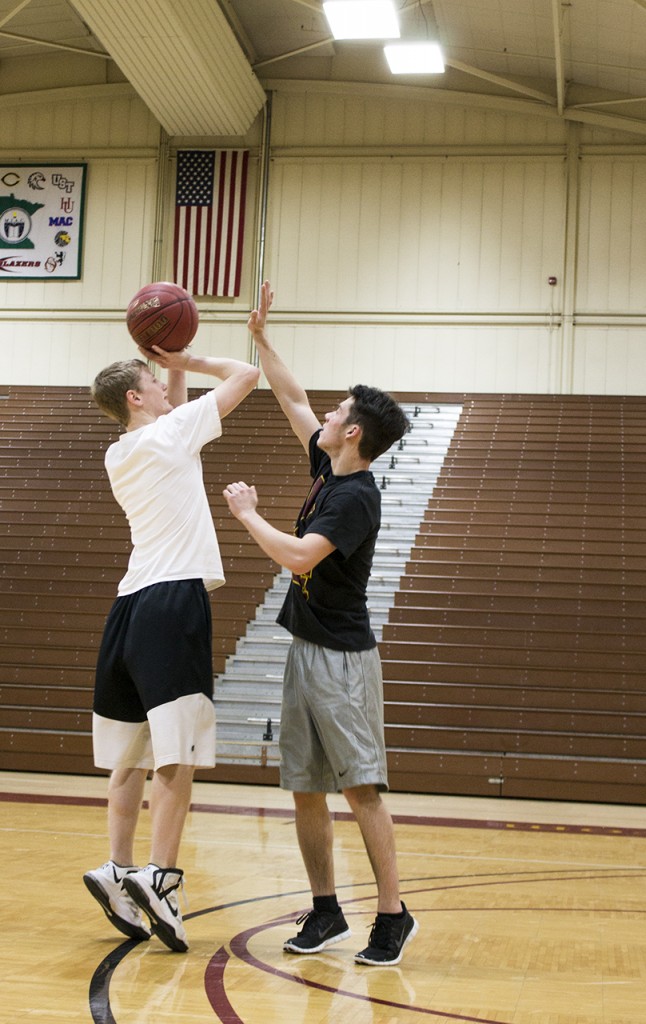 Two Concordia intermural players practice basketball together. 