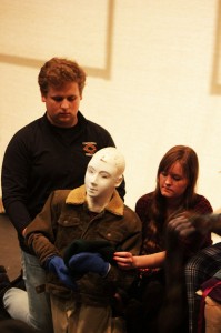 Jonathan Wells and Lisa Uppman work with their bunraku puppet. Below: Actors practice the Suzuki Meth- od with Director David Wintersteen.