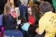Kirsten Henagin and Kjerstin Engebretson play with a therapy dog present at the Concordia Health Fair on March 14.