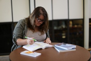 Collins delves into the books of her new major, heritage and museum studies. Photo by Maddie Malat.