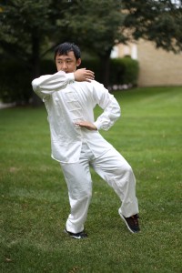 Senior Xao Vang practices Tai Chi for a symposium session. Photo by Maddie Malat.