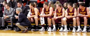 Left to right, assistant coaches Matt Petersen, Grant Hemmingson and head coach Rich Glass watch the game alongside the basketball team. Photo courtesy of the Concordia Sports Information Office.