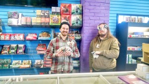 From left to right: Brothers and owners of The Dragon’s Hoard, Jordan and Alex Tepley advertise a variety of their Magic trading cards. Photo by Kaley Sievert.