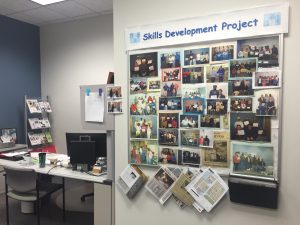 A bulletin board demonstrates a handful of students that have graduated from the Skills Development Project. Photo by Aubrie Odegaard.