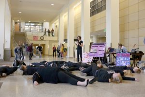 A flash mob in Knutson Campus Center presents an “oil spill.” Photo by Maddie Malat